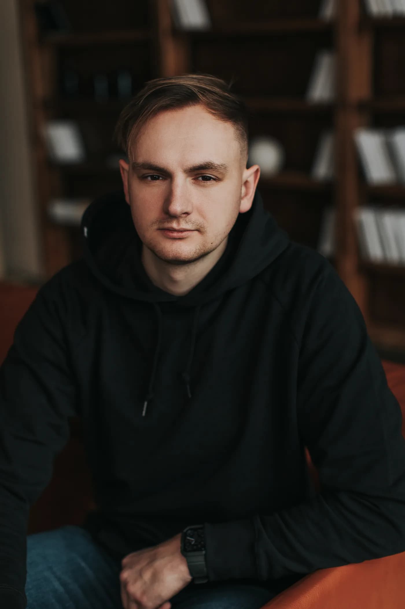 Close portrait of Pavel Bileush in a black hoodie.